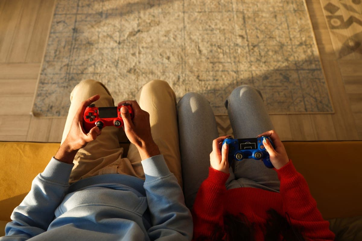 Two controllers side by side on a couch — best cheap games for couples