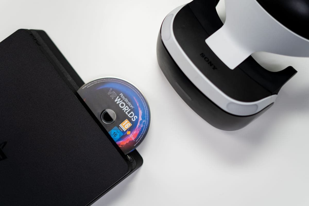A game disc beside a console — physical vs digital games