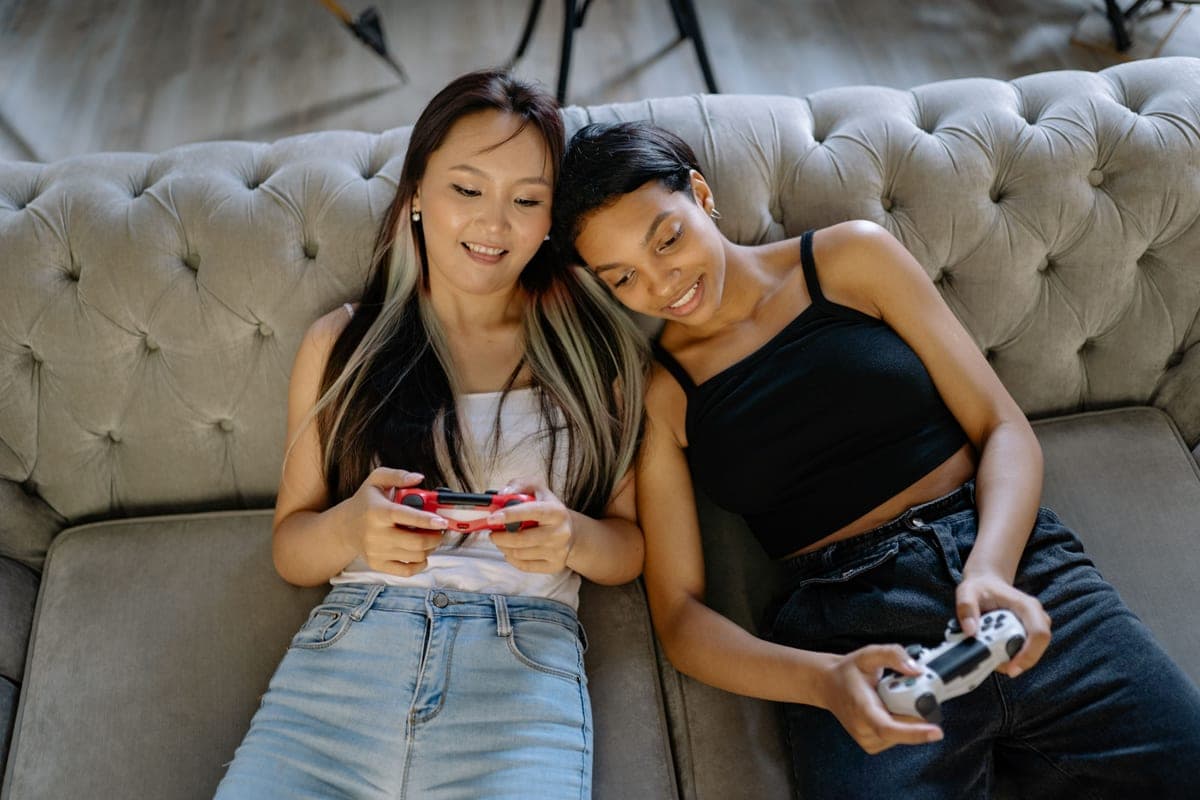 Friends playing games together on a couch — cheap co-op games
